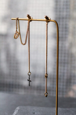 Detailaufnahme Ohrringpaar gold lange Kette und earcuff unten ein Kreuz