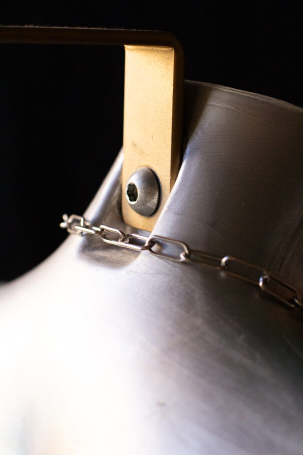 Detailaufnahme Torso mit Bodykette aus Edelstahl und buntem Anhänger in der Mitte